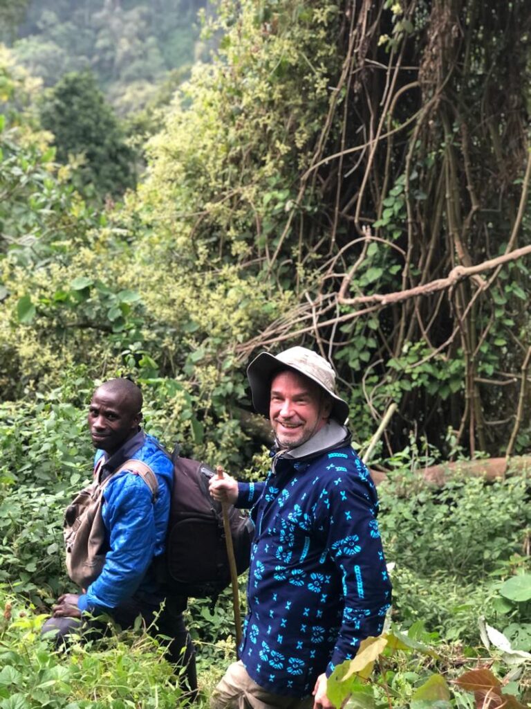 Walking with a local guide through the rainforest in search of mountain gorillas in Uganda
